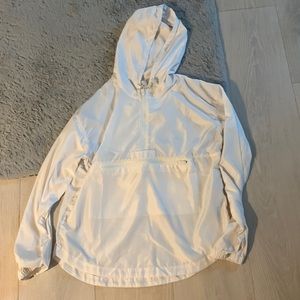 White windbreaker from thread and supply, size mediumand has front zipper pocket